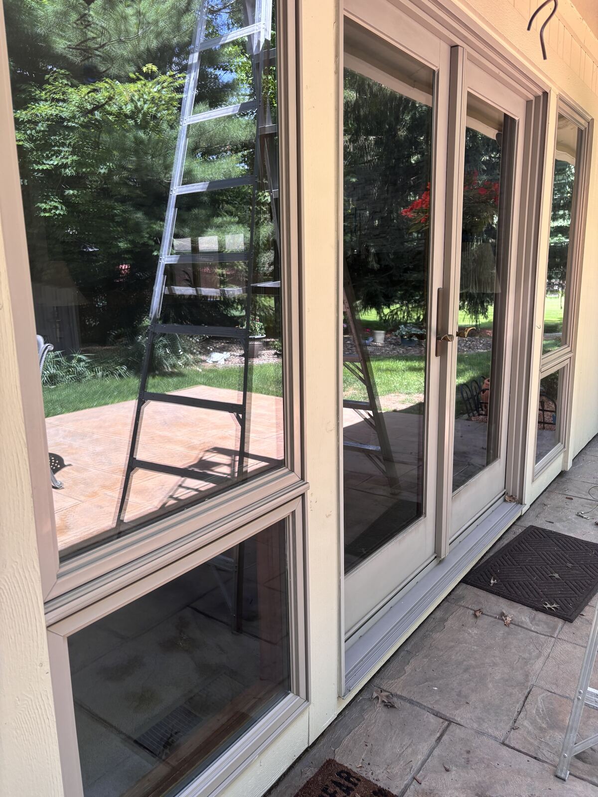 Clean glass door reflecting the yard