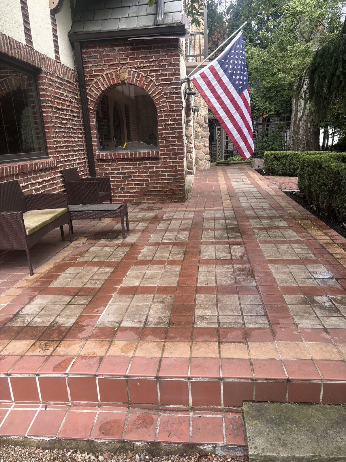 Brick and tile patio before power washing, grimy and stained