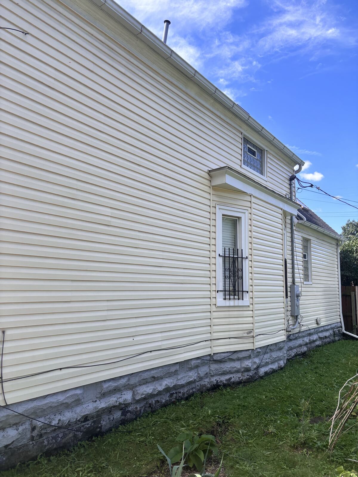 Yellow vinyl siding, freshly power washed