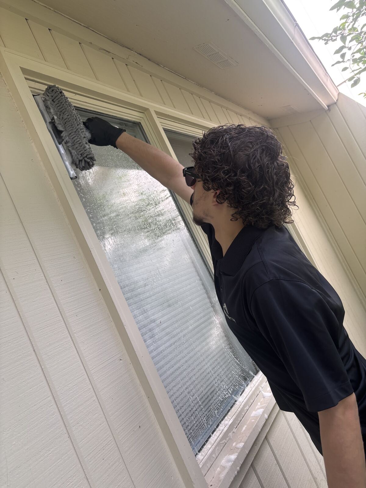 Flex Residential crew member cleaning a window